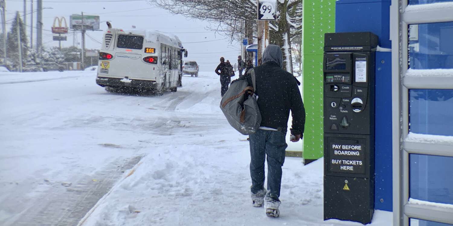 Rider at snowy bus stop