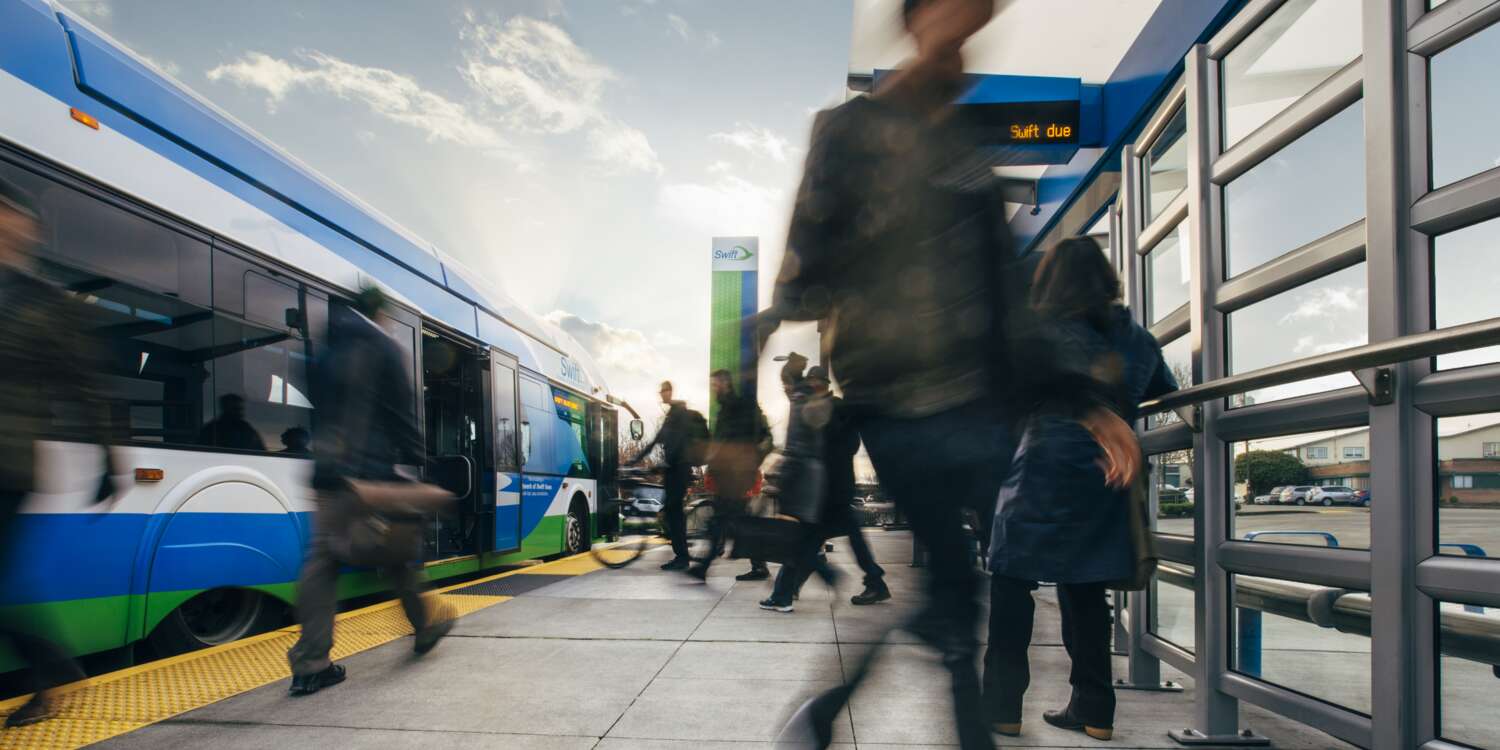 Swift bus pulls away from a stop