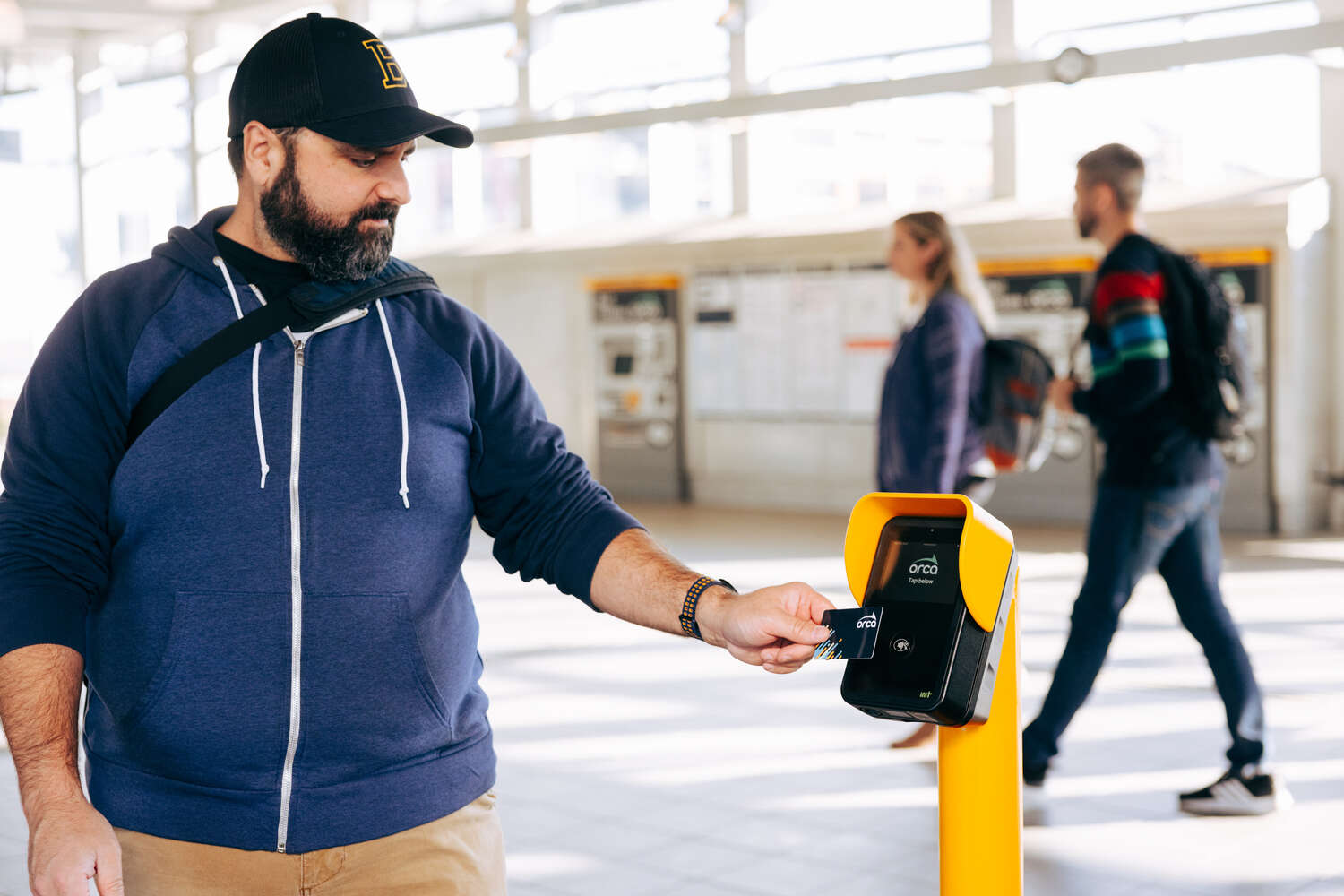 Rider uses ORCA card at bus stop